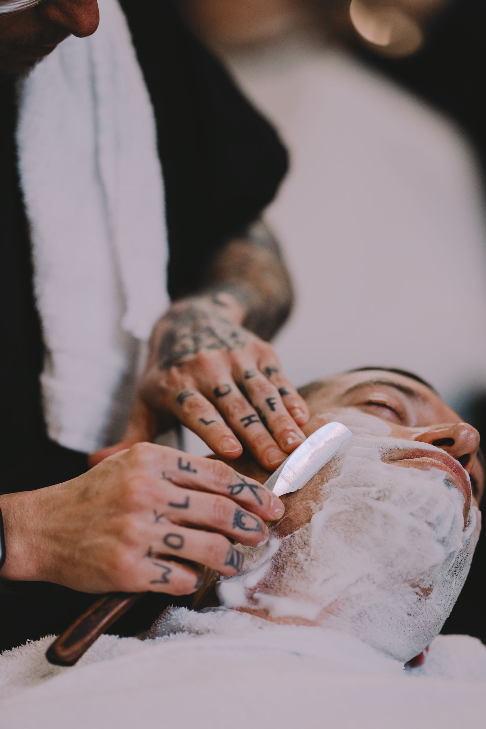 Barber preparing a precise straight-razor beard service