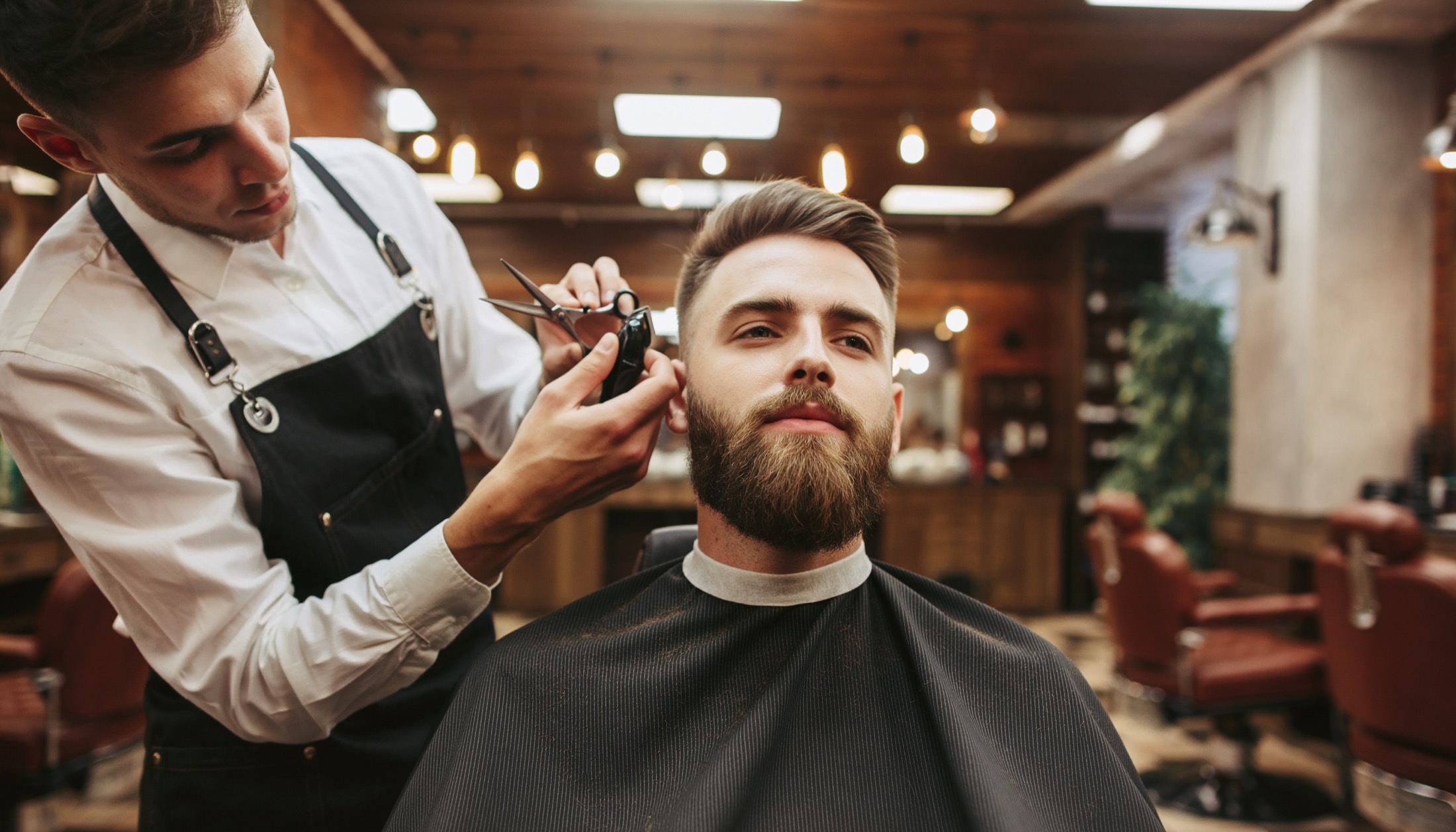 Barber refining the fade on a client's haircut.