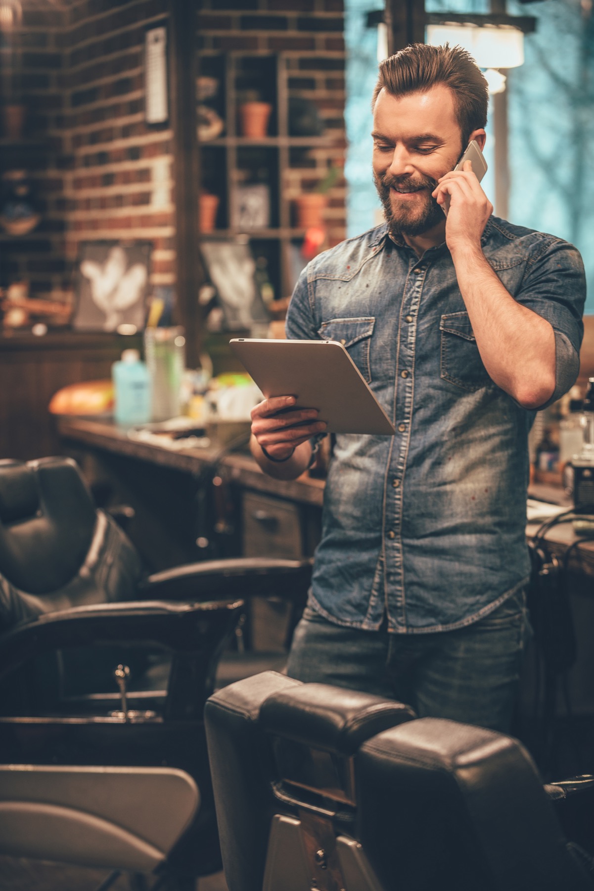 Client arranging a barber appointment by phone.