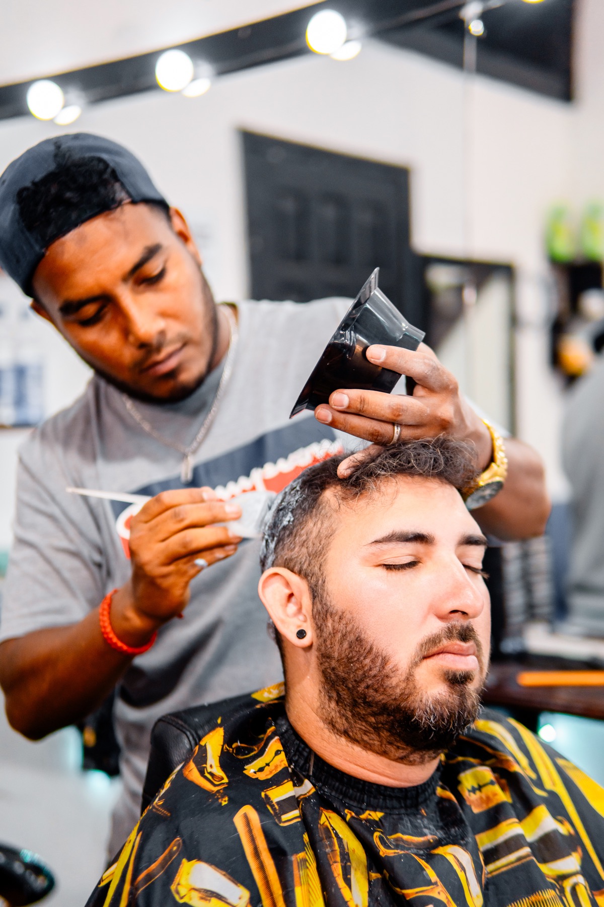 Barber applying a creative color service.
