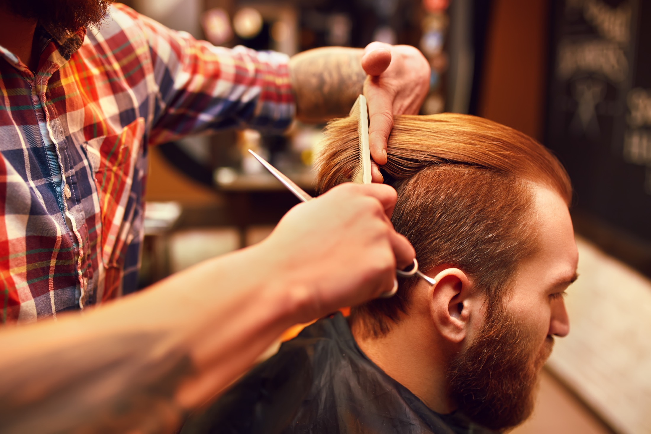 Detailed clipper work on a modern beard and haircut.